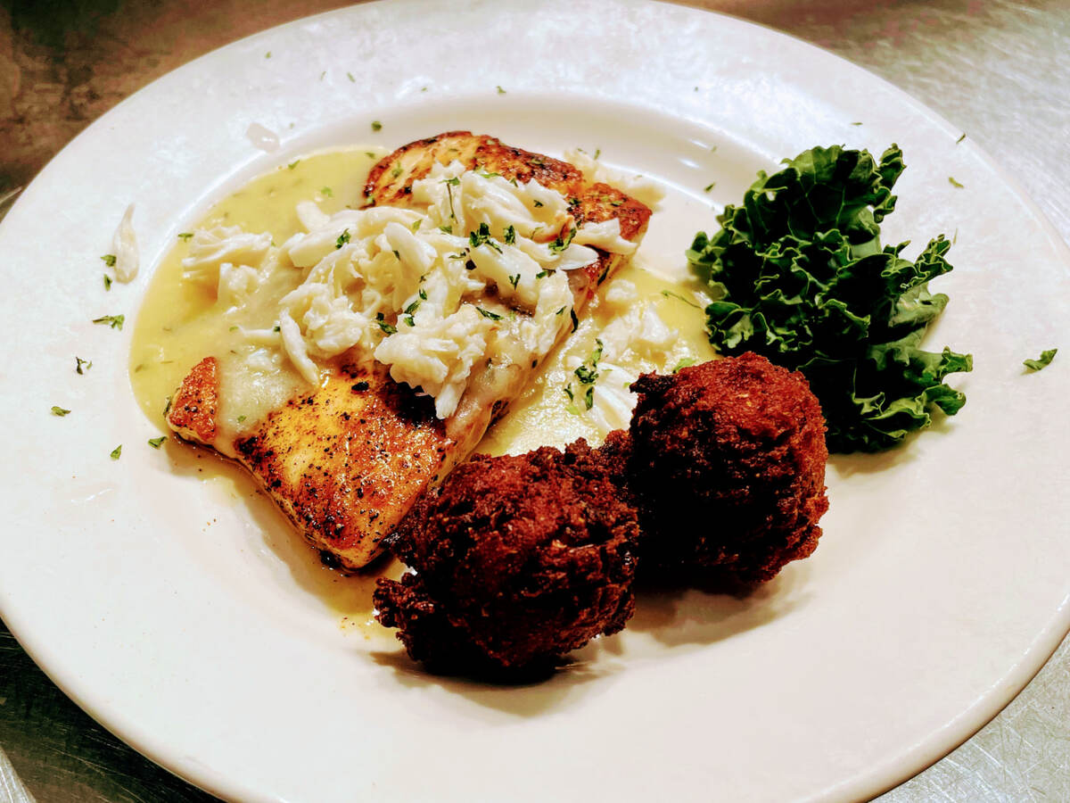 Blackened grouper topped with lump crab meat and hush puppies at The Point Restaurant Perdido