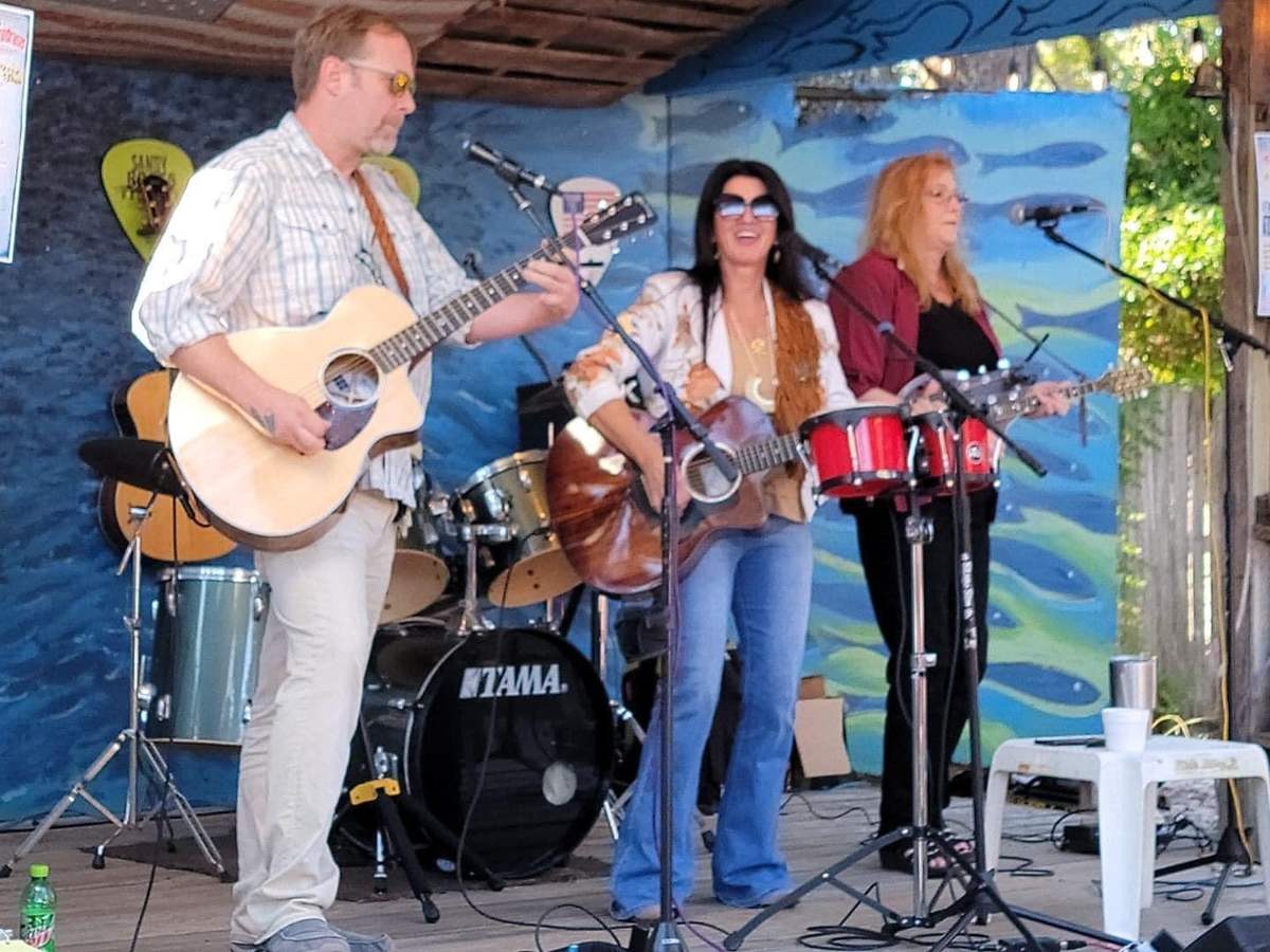 Live band performing on the mural stage at The Courtyard, The Point Restaurant Perdido