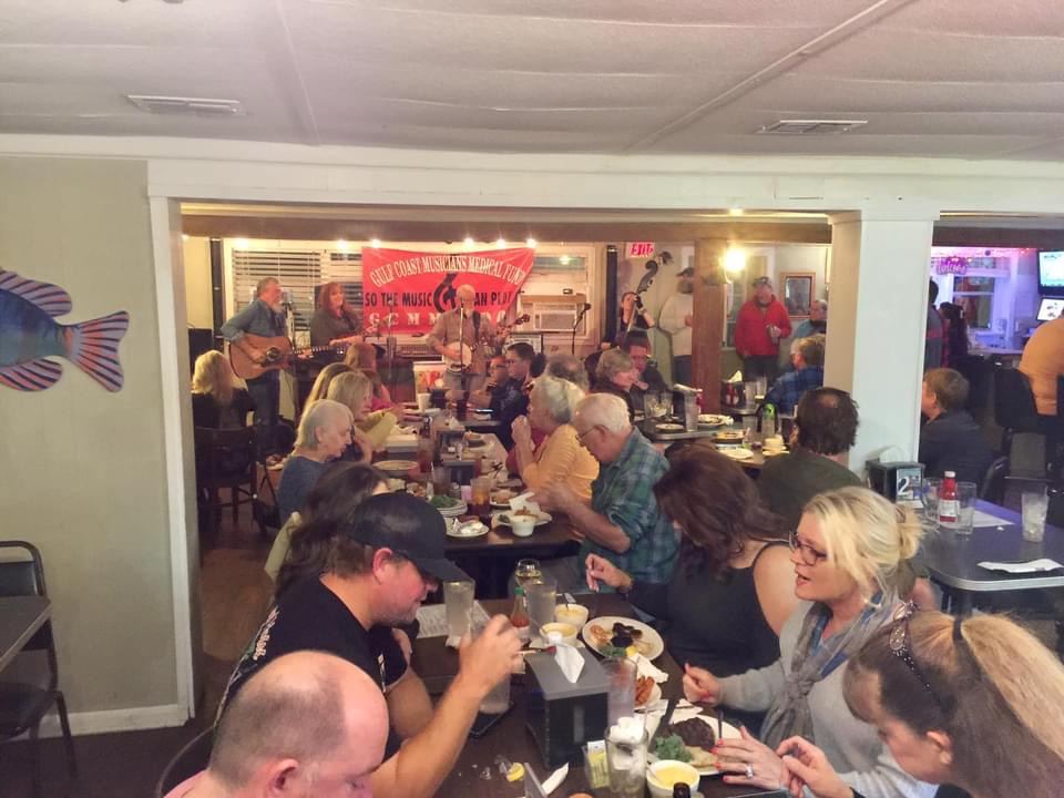 Band playing to a packed dining room during a benefit at The Point Restaurant Perdido