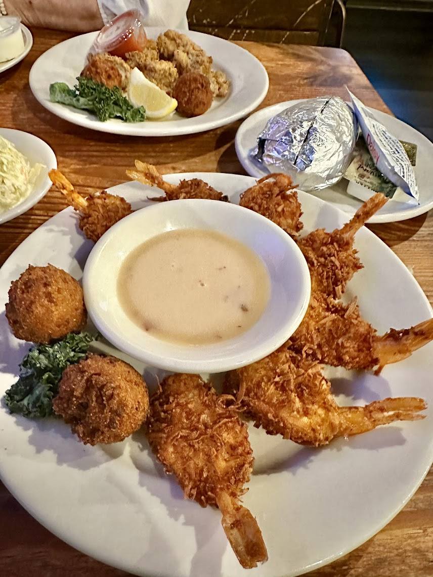 Coconut fried shrimp platter with hush puppies and dipping sauce at The Point Restaurant Perdido