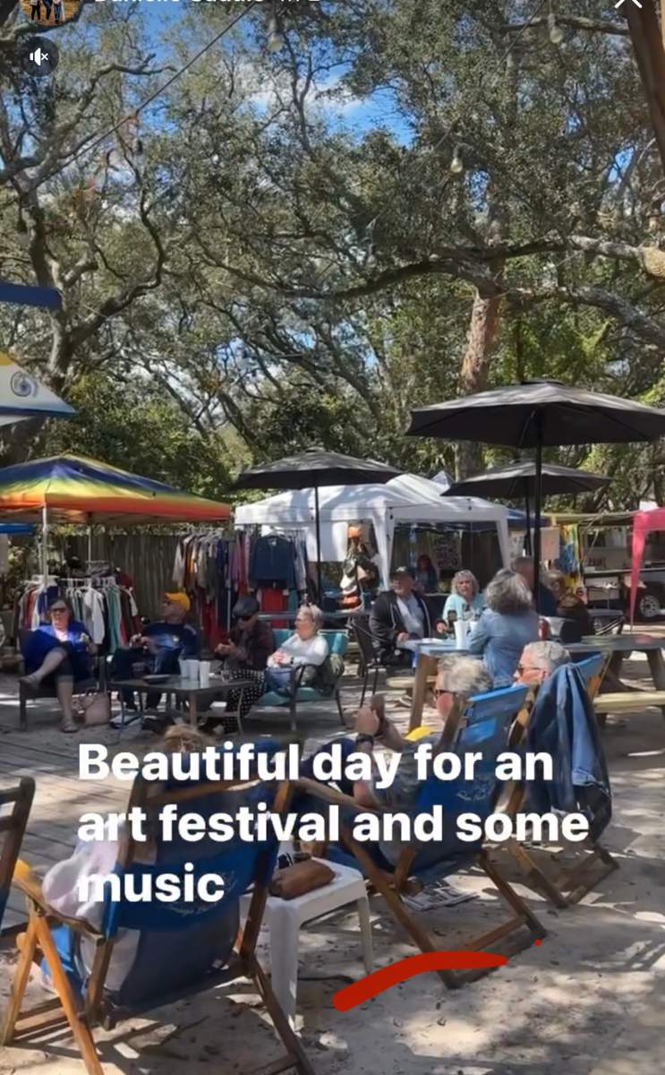 Guests relaxing in beach chairs during an art festival in The Courtyard at The Point Restaurant Perdido, FL