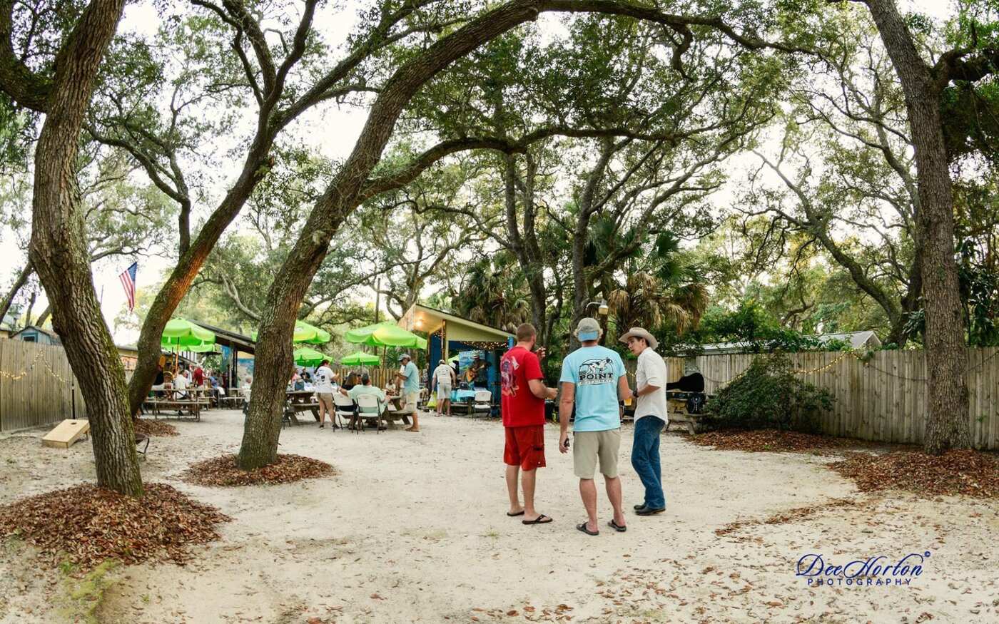 Guests under the live oaks in The Courtyard at The Point Restaurant Perdido, FL