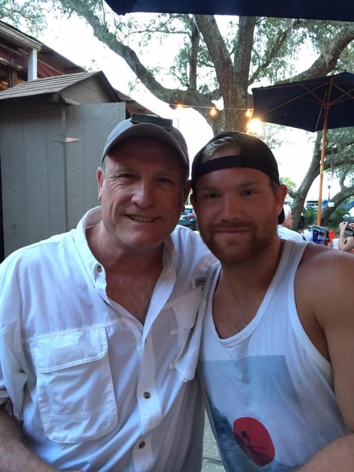 Two guests smiling together in The Courtyard at The Point Restaurant Perdido